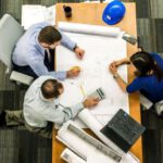 Project Management - Three People Sitting Beside Table