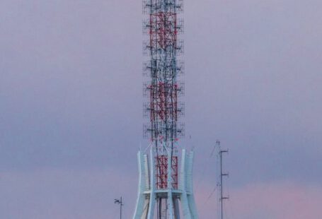Effective Communication - A tall building with a radio tower on top